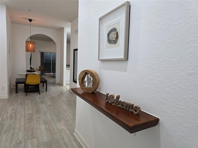 corridor with light hardwood / wood-style flooring