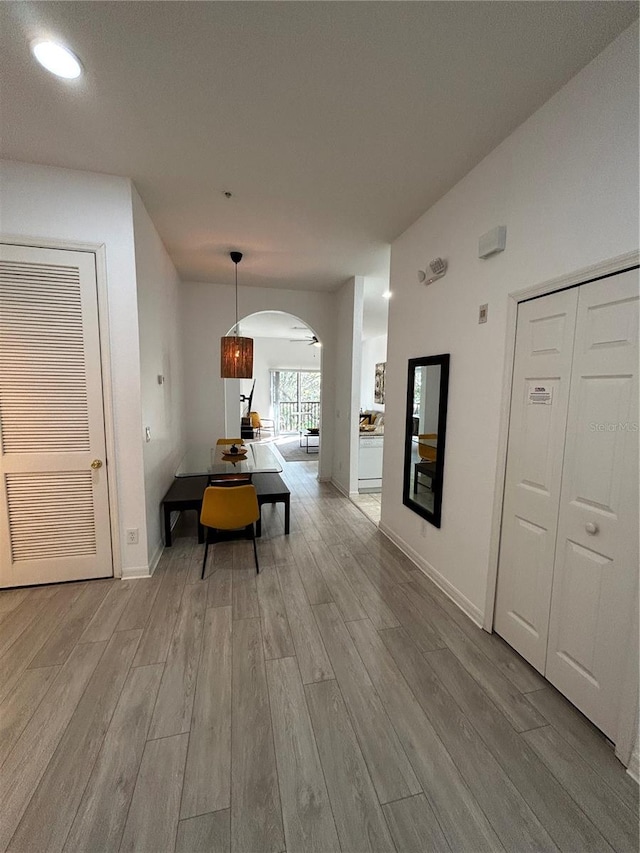 dining space with light wood-type flooring and vaulted ceiling