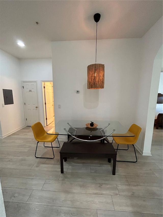 dining area featuring light hardwood / wood-style floors and electric panel