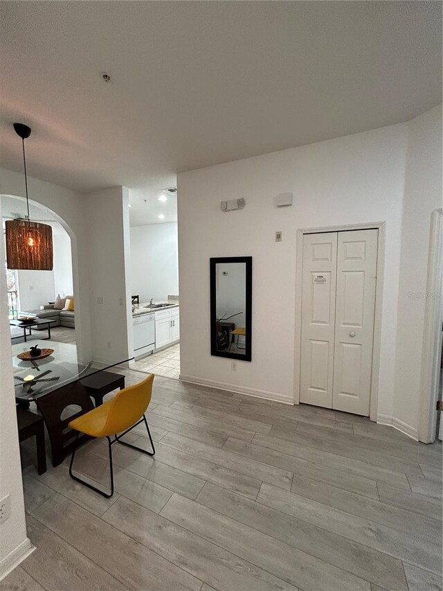 dining room with sink and light hardwood / wood-style floors