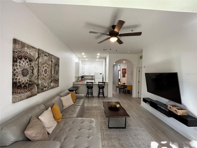 living room with hardwood / wood-style flooring and ceiling fan