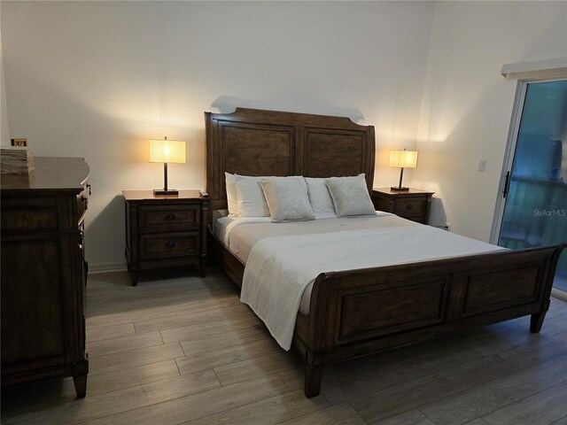 bedroom with hardwood / wood-style flooring