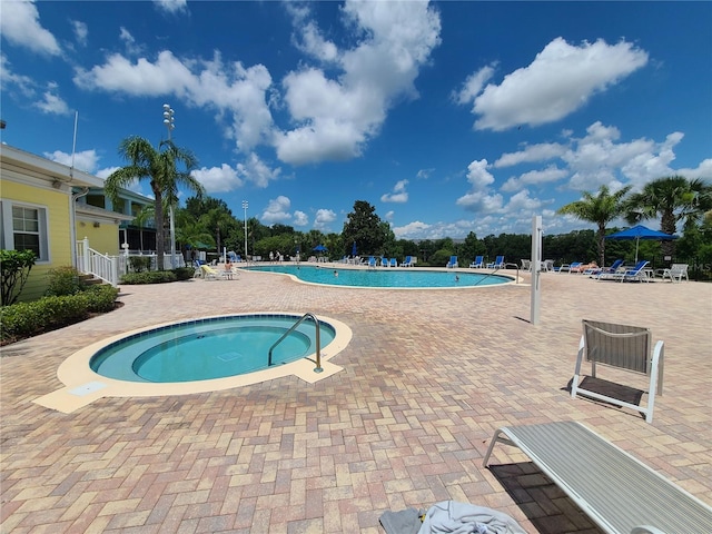 view of pool with a patio area and a community hot tub