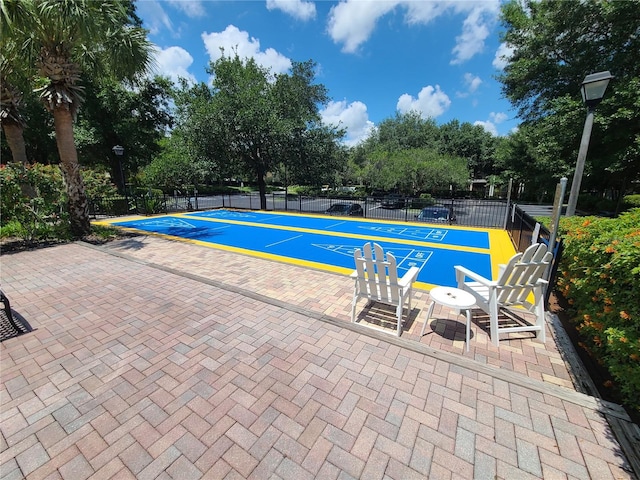 view of swimming pool with tennis court