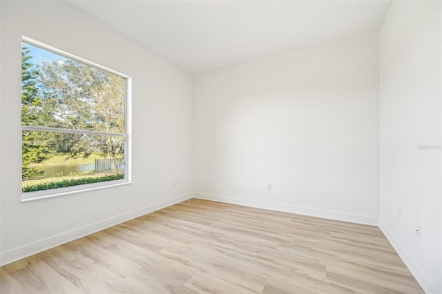 unfurnished room with light hardwood / wood-style flooring and a healthy amount of sunlight