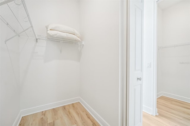 walk in closet featuring hardwood / wood-style floors