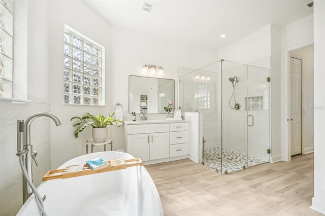 bathroom with vanity, wood-type flooring, and walk in shower