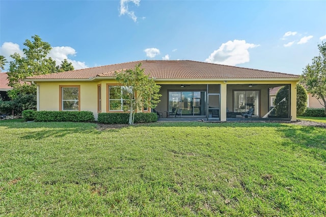 back of house featuring a yard and a sunroom