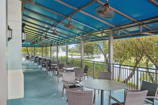 sunroom / solarium featuring a water view