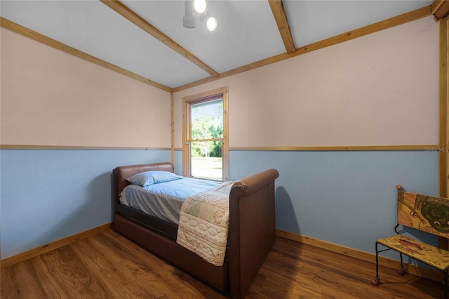 bedroom with dark wood-type flooring, ceiling fan, and lofted ceiling with beams