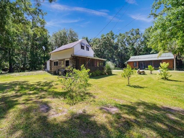 view of yard with a sunroom