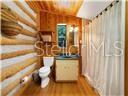 bathroom featuring toilet, wood ceiling, and wood-type flooring