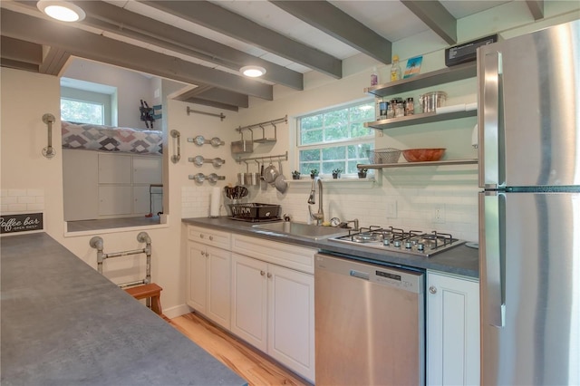 kitchen featuring white cabinets, tasteful backsplash, stainless steel appliances, and sink