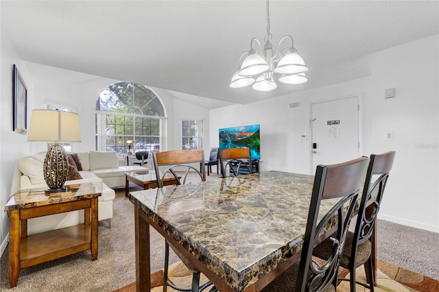 carpeted dining space featuring vaulted ceiling and a notable chandelier