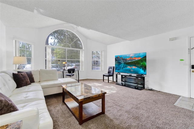 carpeted living room with a textured ceiling, ceiling fan, and vaulted ceiling