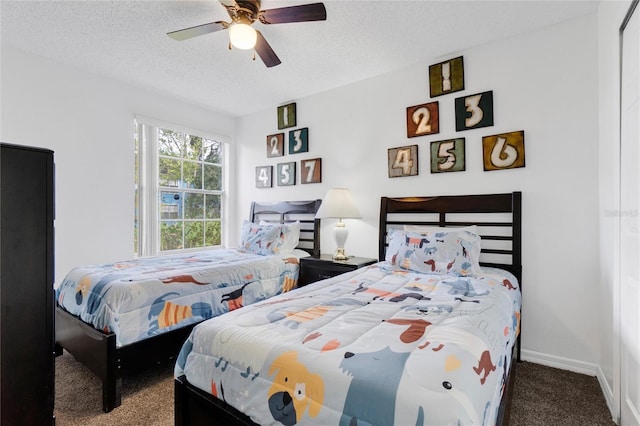 bedroom with a textured ceiling, carpet flooring, and ceiling fan