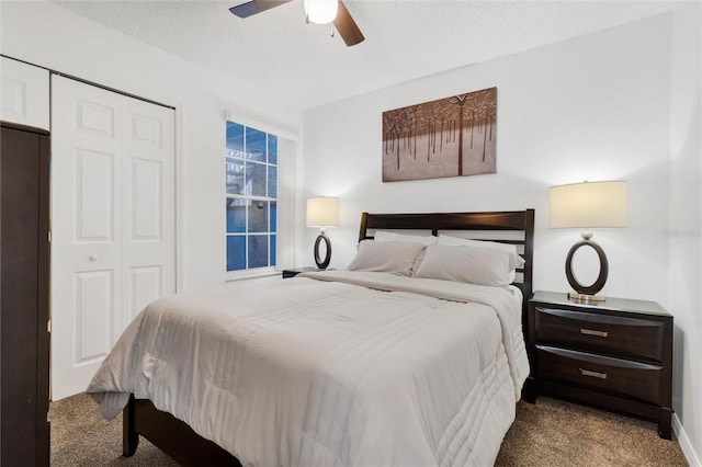 carpeted bedroom featuring a closet, ceiling fan, and a textured ceiling