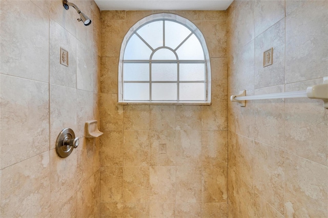 bathroom with tiled shower