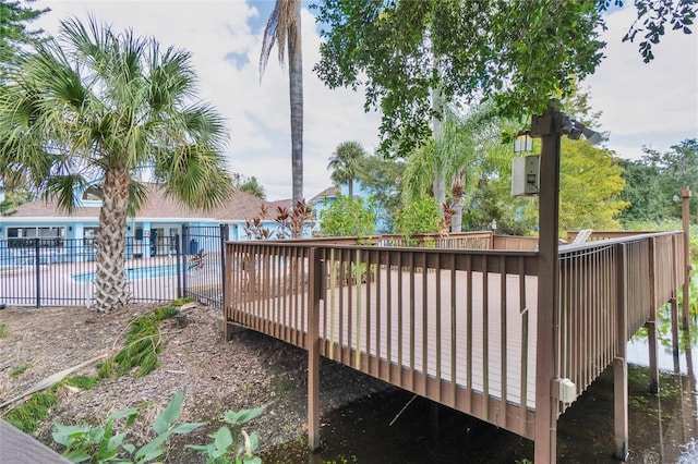 wooden deck featuring a community pool