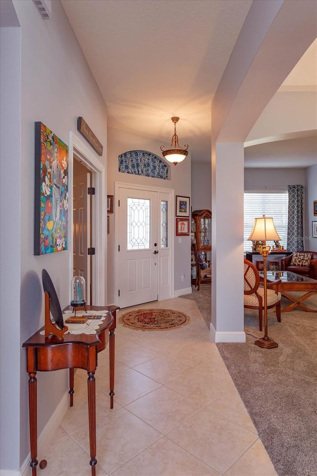 foyer entrance with light colored carpet