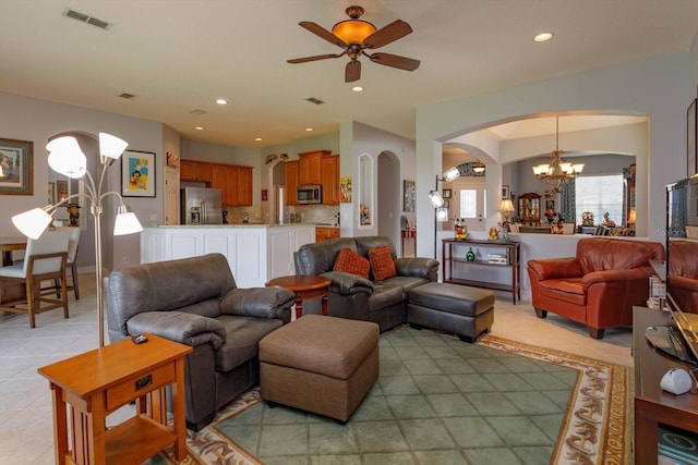 living room featuring light tile patterned floors and ceiling fan with notable chandelier