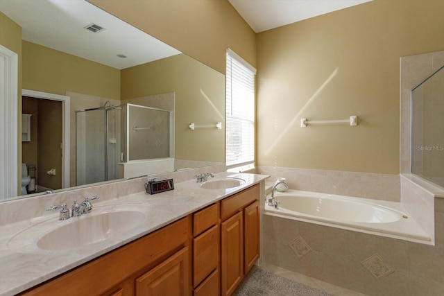 full bathroom featuring vanity, toilet, and shower with separate bathtub