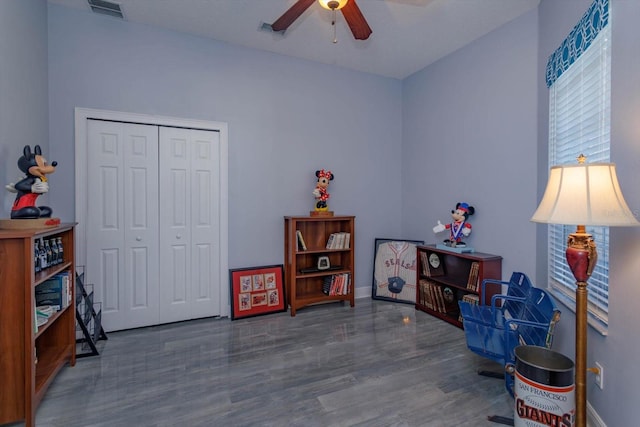 misc room featuring dark wood-type flooring and ceiling fan