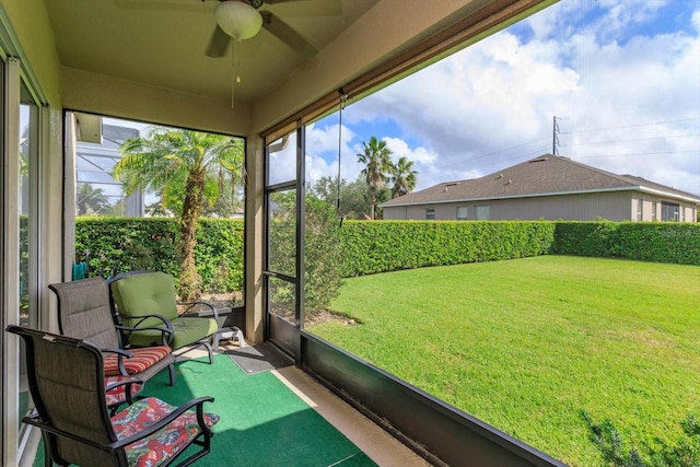 unfurnished sunroom with ceiling fan