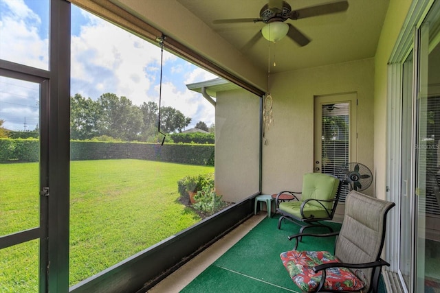 sunroom / solarium featuring ceiling fan