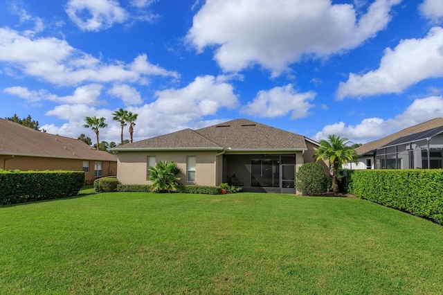 rear view of property with a yard