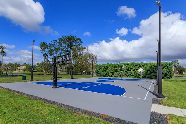 view of basketball court with a yard