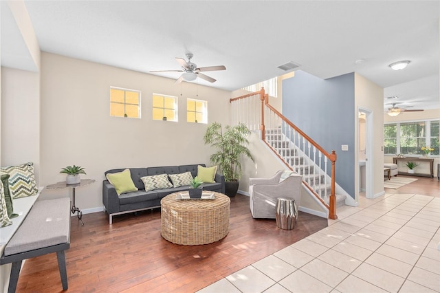 living room with light hardwood / wood-style flooring and ceiling fan