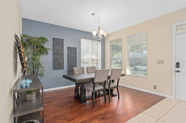 dining space featuring a notable chandelier and hardwood / wood-style floors