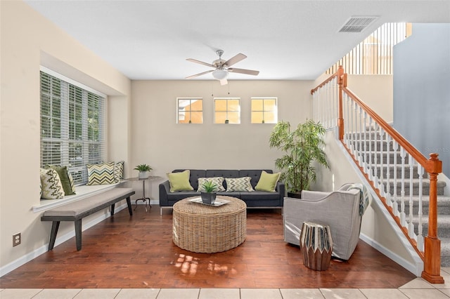 living room featuring ceiling fan and hardwood / wood-style flooring