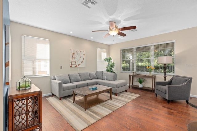 living room with ceiling fan and dark hardwood / wood-style flooring