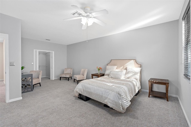 carpeted bedroom featuring a closet and ceiling fan