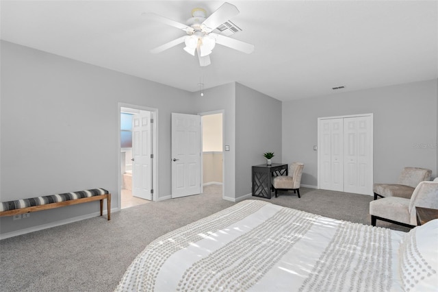 bedroom featuring a closet, ceiling fan, light carpet, and ensuite bath