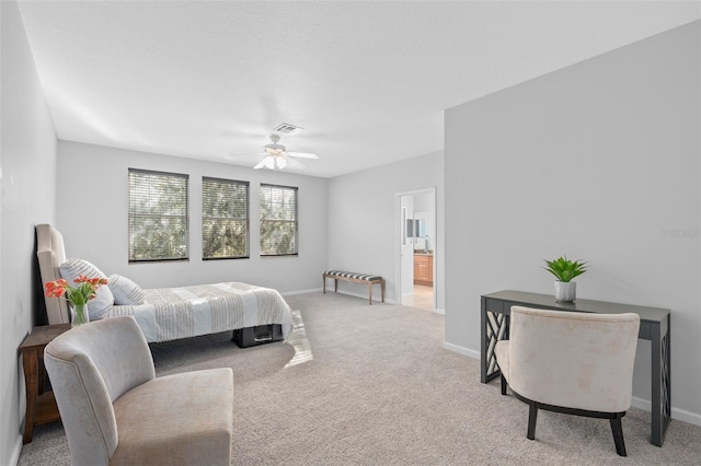 carpeted bedroom featuring connected bathroom and ceiling fan