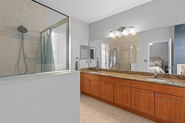 full bath featuring a sink, connected bathroom, tile patterned floors, and a stall shower