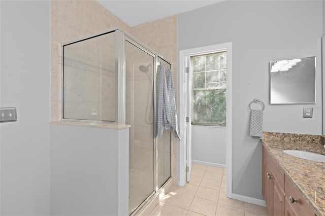 bathroom with vanity, a shower with shower door, and tile patterned flooring