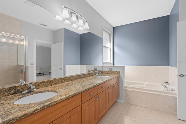 bathroom featuring vanity, independent shower and bath, and tile patterned flooring