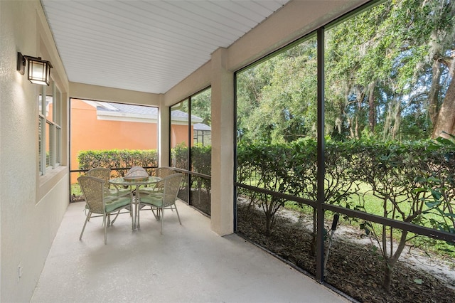 sunroom with outdoor dining area