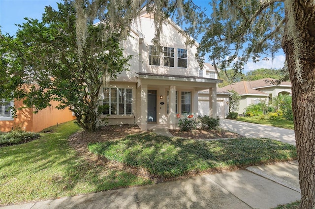 view of front of home with a front yard, covered porch, and a garage