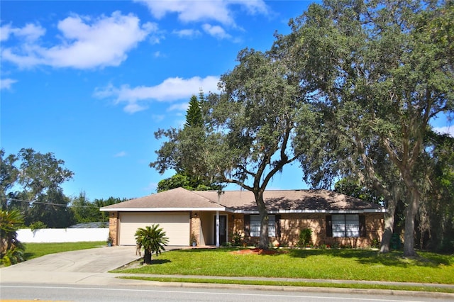 view of front of home with a front lawn and a garage