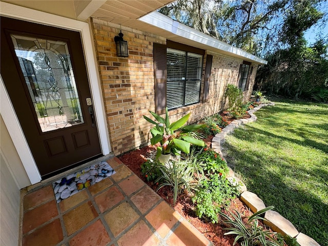 doorway to property with a lawn