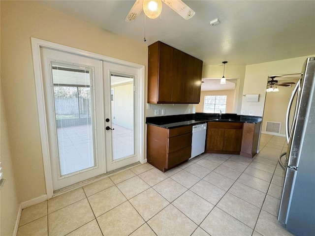 kitchen with french doors, a healthy amount of sunlight, and stainless steel refrigerator