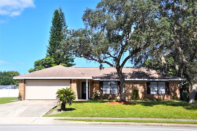 ranch-style house featuring a front yard and a garage