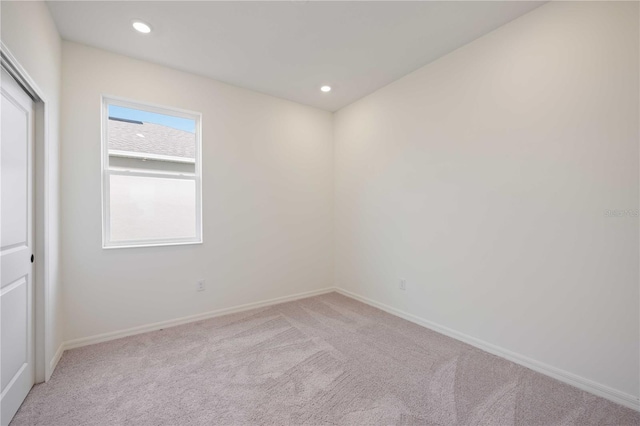 spare room with light colored carpet