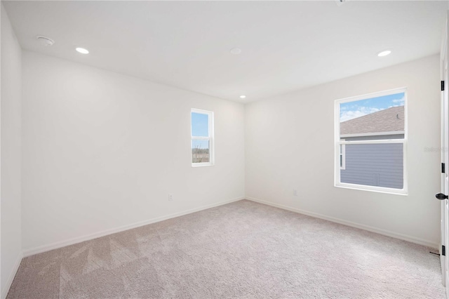 unfurnished room with light carpet