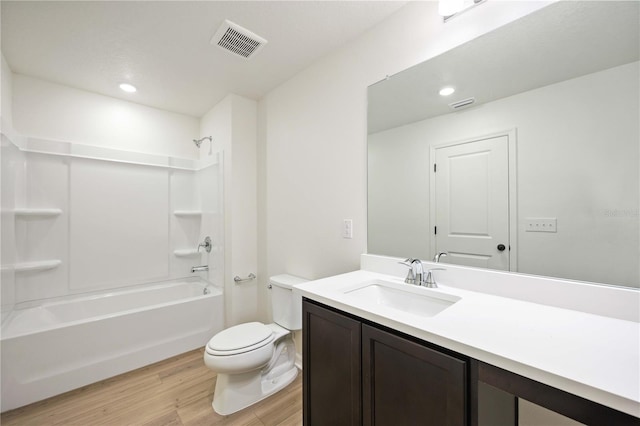 full bathroom featuring vanity, tub / shower combination, hardwood / wood-style floors, and toilet